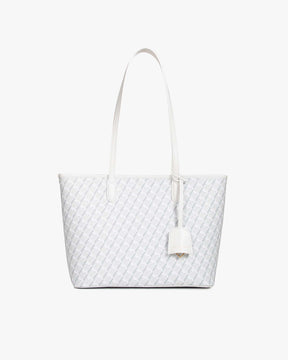 TOTE MONOGRAM PM blanc ivoire, vue de face posé, anses plates et porte-adresse en cuir