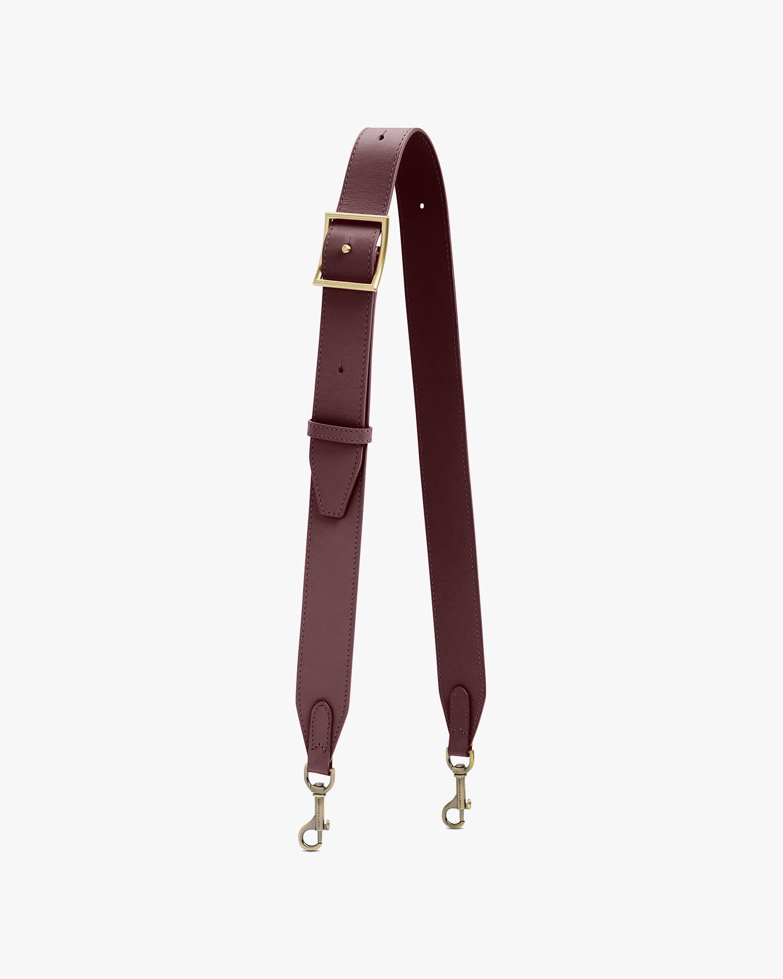 Adjustable wide strap Aubergine, laid out in a U-shape, aged brass buckle and visible clasps