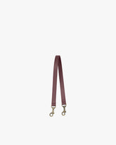 Short strap in leather, Aubergine color, laid flat, aged brass clasps at both ends