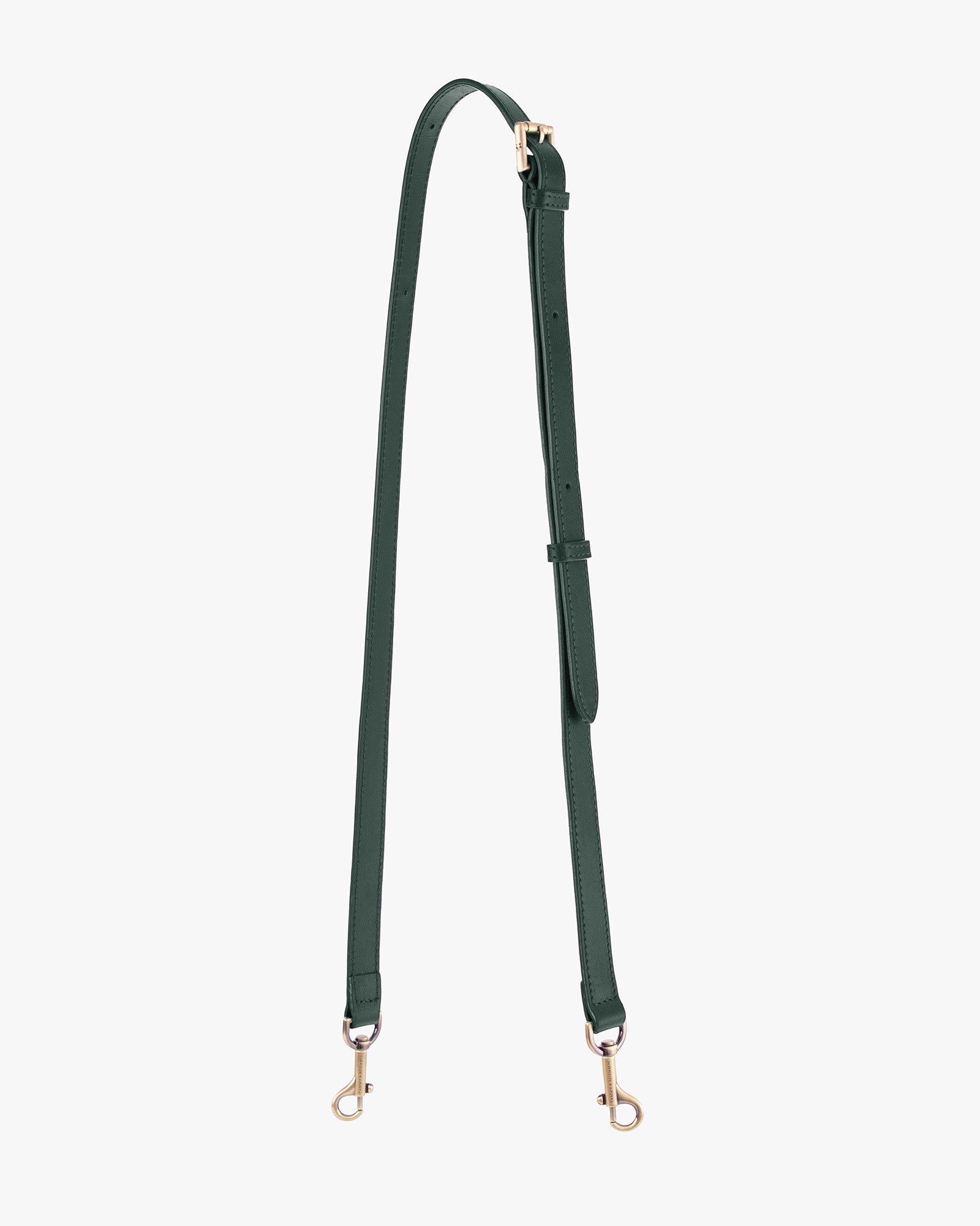 Adjustable thin strap in emerald green laid out full length, showing jewel buckle and gold-tone clasps