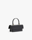 THEA MINI bag in black naplak, rear three-quarter view, standing, showing flap and handle
