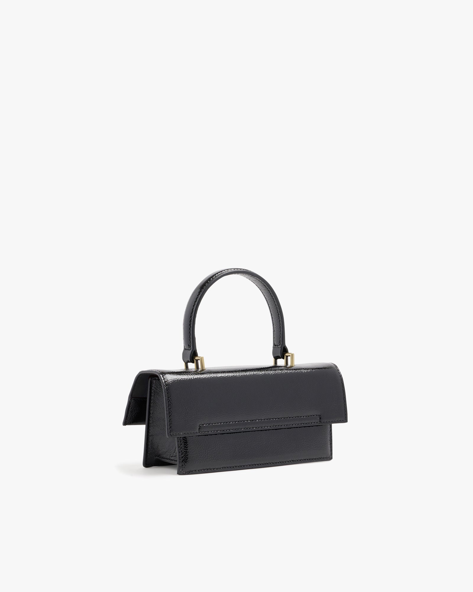THEA MINI bag in black naplak, rear three-quarter view, standing, showing flap and handle
