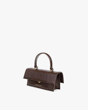Sac THEA MINI brun embossé lézard, vue de profil, posé, anse courte relevée
