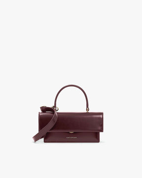 THEA MINI bag in Mahogany, front view, flap closed, top handle with detachable strap