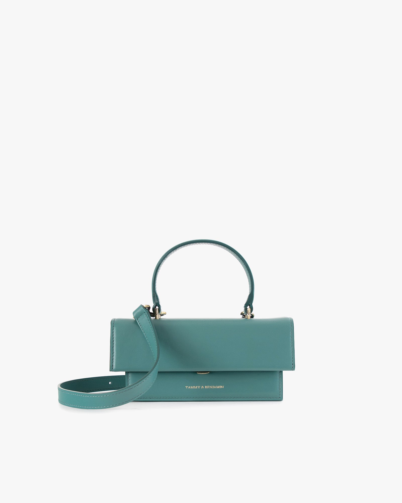 THEA MINI bag in turquoise, front view, flap closed, top handle raised with detachable strap resting in front