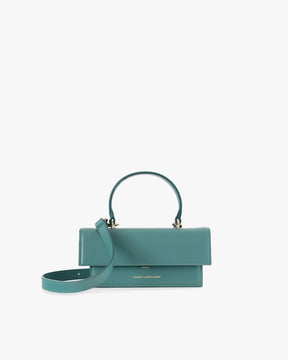 THEA MINI bag in turquoise, front view, flap closed, top handle raised with detachable strap resting in front
