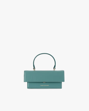 THEA MINI bag in turquoise, front view, standing, top handle raised, flap closure visible