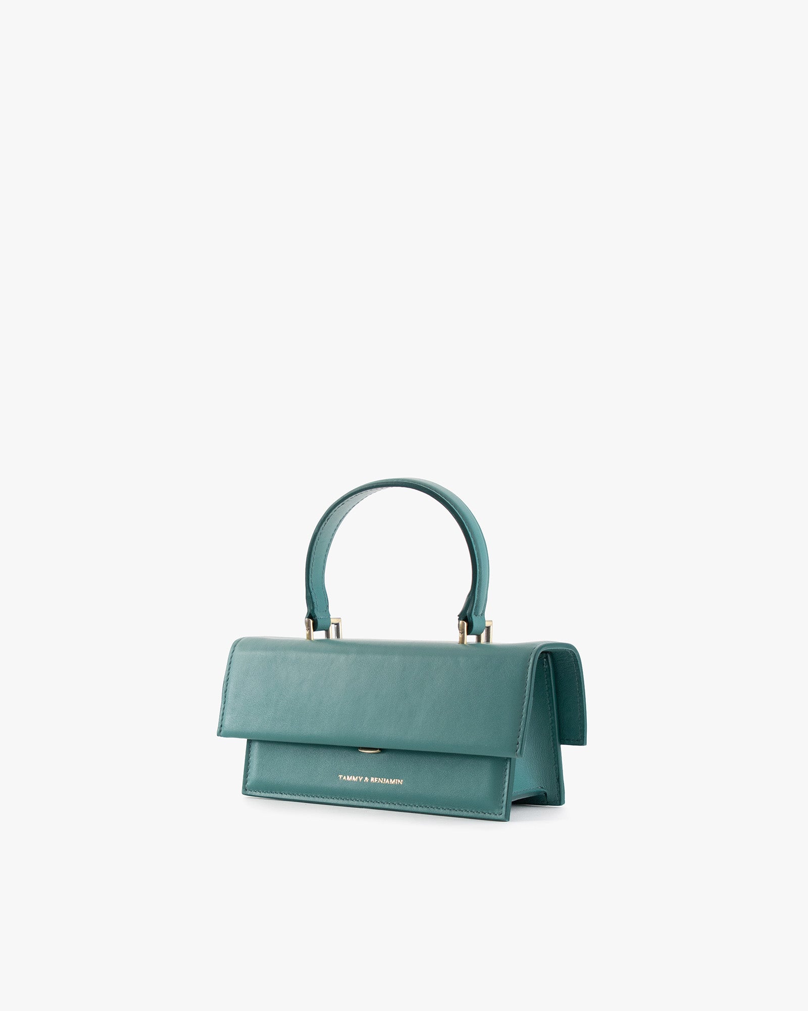 THEA MINI bag in turquoise, three-quarter view, flap closed, top handle, white background