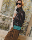 THEA MINI turquoise bag worn crossbody, side view, flap and handle detail