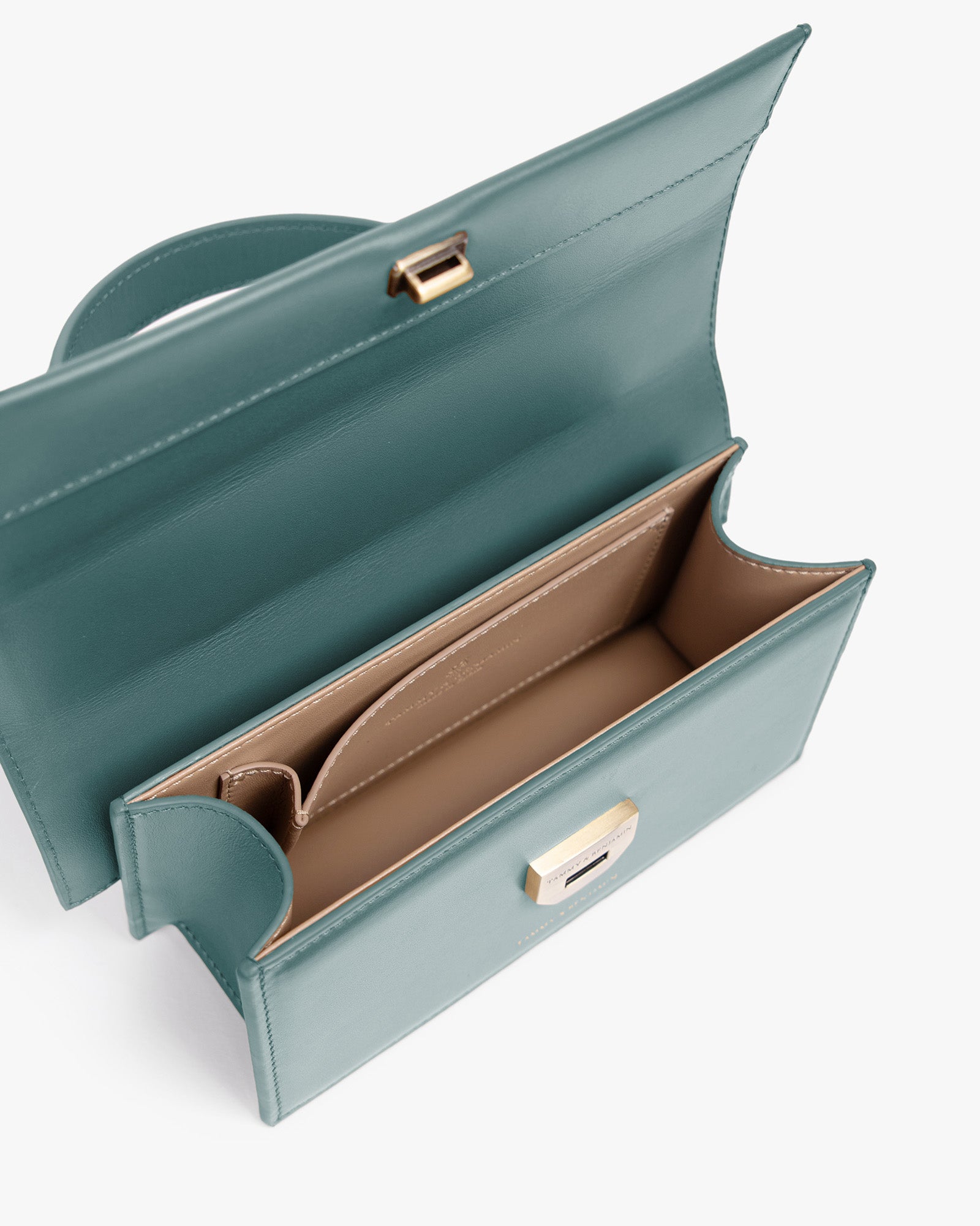 THEA MINI bag in turquoise, open top view showing the flap and beige compartmented interior