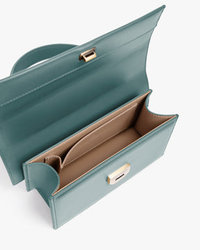 THEA MINI bag in turquoise, open top view showing the flap and beige compartmented interior