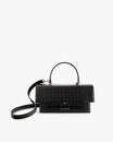 Sac THEA Noir - Embossé Crocodile de face, poignée rigide et bandoulière détachée, posé
