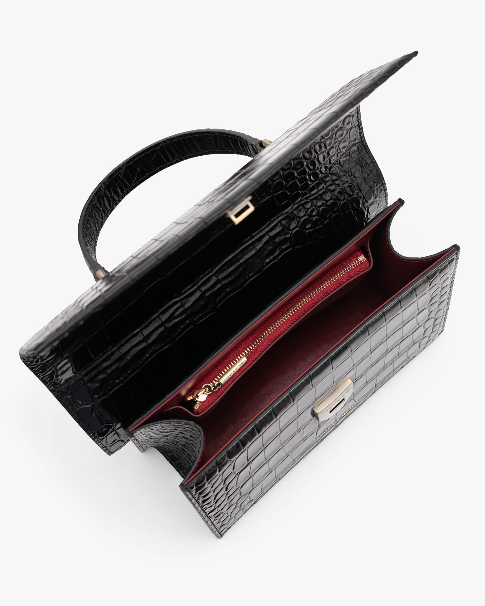 Sac THEA noir embossé crocodile, vue intérieure ouverte, poche zippée rouge et poignée rigide