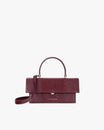 Sac THEA Bordeaux Embossé Lézard, vue de face, posé, avec poignée rigide et bandoulière
