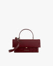 Sac THEA en cuir naplak bordeaux, vue de face, posé, avec rabat oversize et poignée rigide