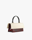 Sac THEA Colourblock art déco de profil, rabat surdimensionné, anse noire, posé