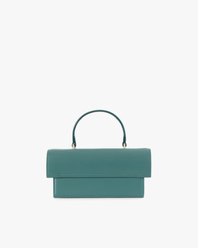 Sac THEA Turquoise de face, posé, rabat fermé et poignée rigide relevée