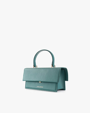 Sac THEA turquoise de trois quarts, rabat fermé, anse rigide relevée