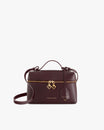Sac VAYA Aubergine de face, anse courte, breloques Key Bell dorées et étiquette cuir sur le zip