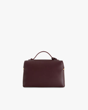 Sac VAYA Aubergine de dos, posé, avec anse portée à la main et détail Key Bell doré