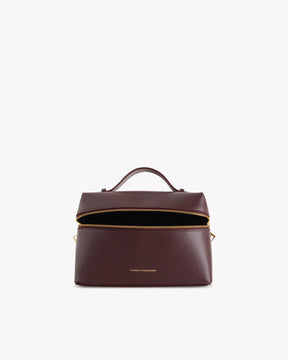 Sac VAYA Aubergine en cuir, vue de face ouvert, zip détaché montrant l'intérieur noir