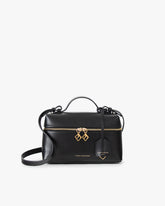 Sac VAYA noir, vue de face avec anse courte et bandoulière, zip doré et breloques Key Bell