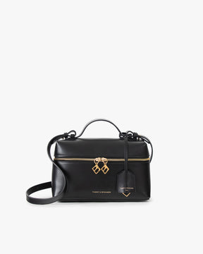 Sac VAYA noir, vue de face avec anse courte et bandoulière, zip doré et breloques Key Bell
