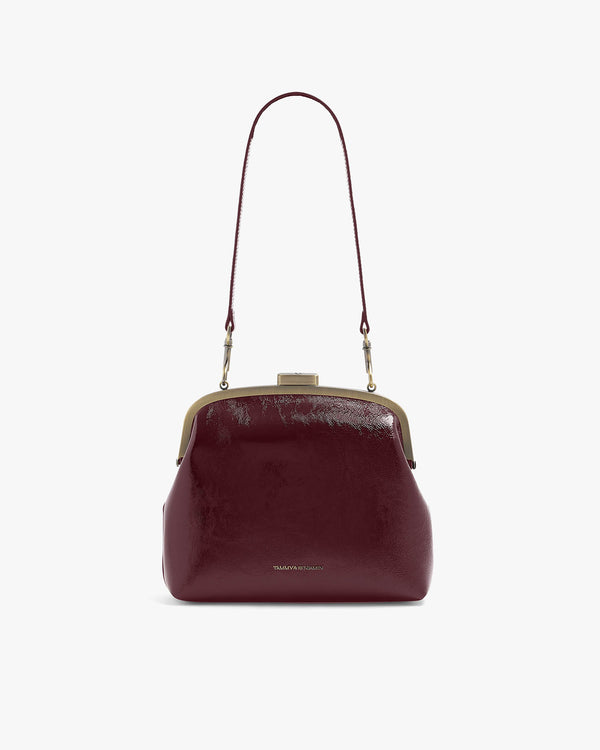 EMMA bag in Bordeaux naplak, front view with shoulder strap, clasp closure visible