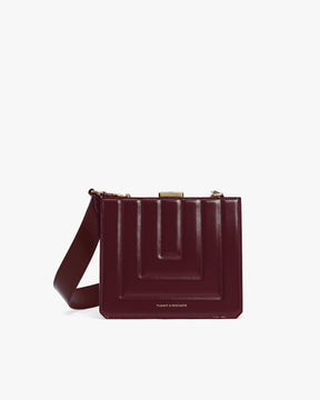 JUDE bag in quilted Mahogany, front view, gold clasp, worn crossbody
