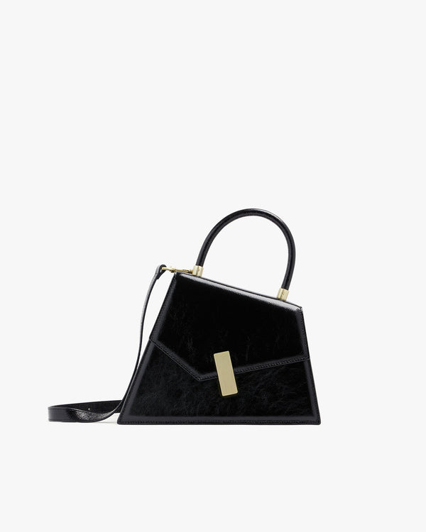 Sac CUBIST Noir naplak, vue de profil, poignée ronde et bandoulière fine ajustable, fermoir doré rectangulaire