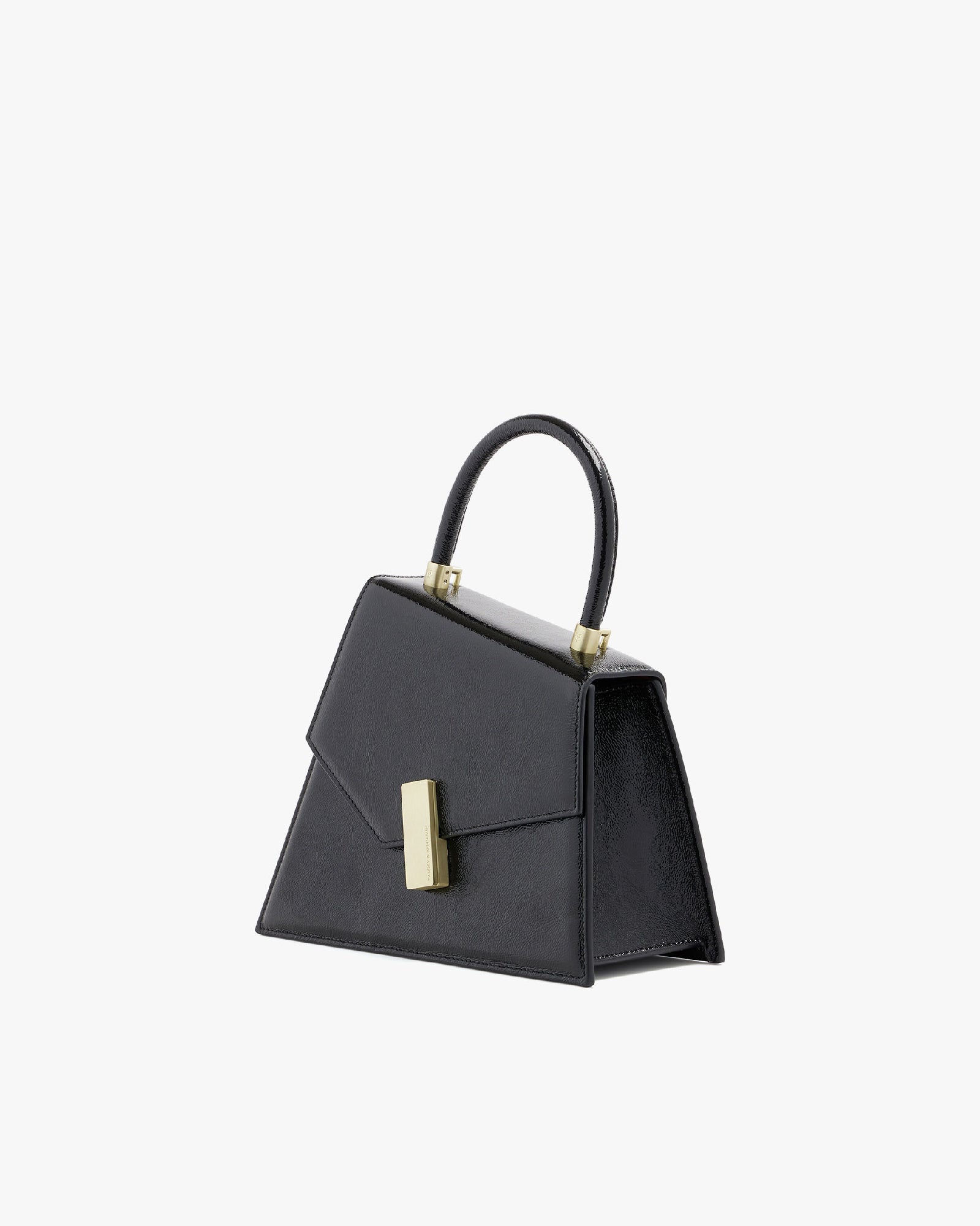 Sac CUBIST en noir naplak, vue de trois quarts, posé, fermoir doré et anse supérieure visibles