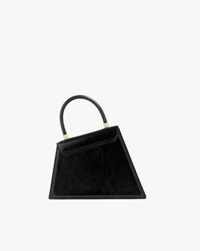 Sac CUBIST noir naplak, vue de trois quarts, poignée relevée, posé sur fond blanc