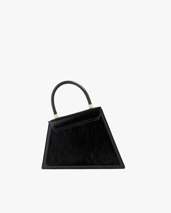 Sac CUBIST noir naplak, vue de trois quarts, poignée relevée, posé sur fond blanc