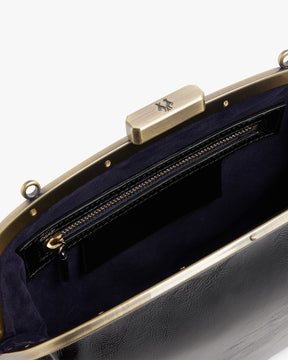 EMMA bag in black naplak, open interior view showing gold clasp and zip pocket