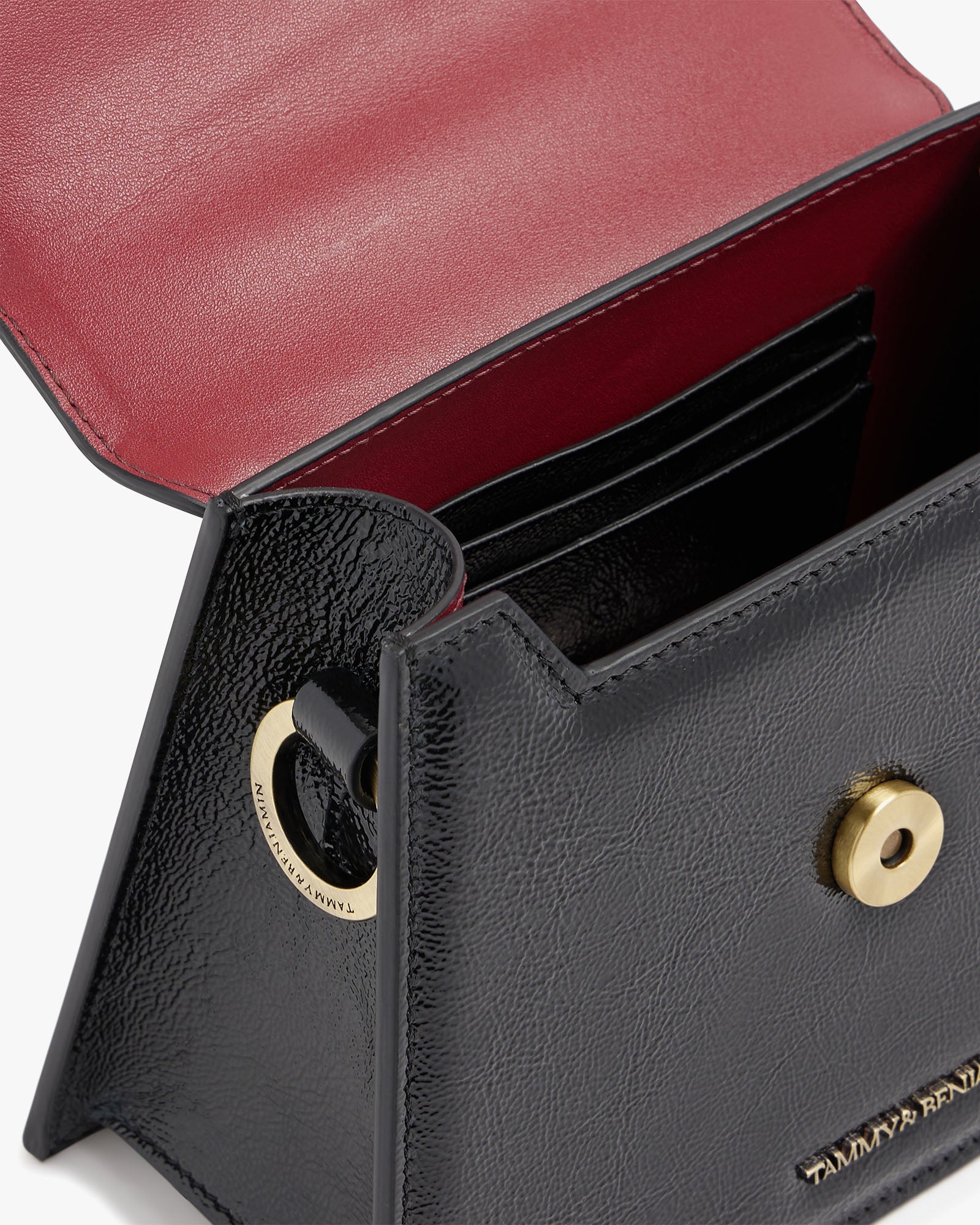 GABRIELLE bag in black naplak leather, open view showing card slots and gold turn-lock clasp