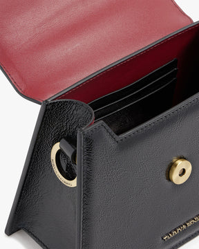GABRIELLE bag in black naplak leather, open view showing card slots and gold turn-lock clasp
