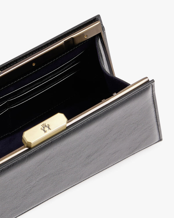 JAY bag in black naplak, open close-up view of the gold clasp and padded interior