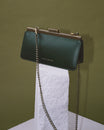 JEANNE BAGUETTE bag in emerald green, side view, retro gold clasp, removable chain, displayed