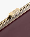 Sac JEANNE BAGUETTE Mahogany, détail du fermoir rétro gravé sur le rabat bordeaux