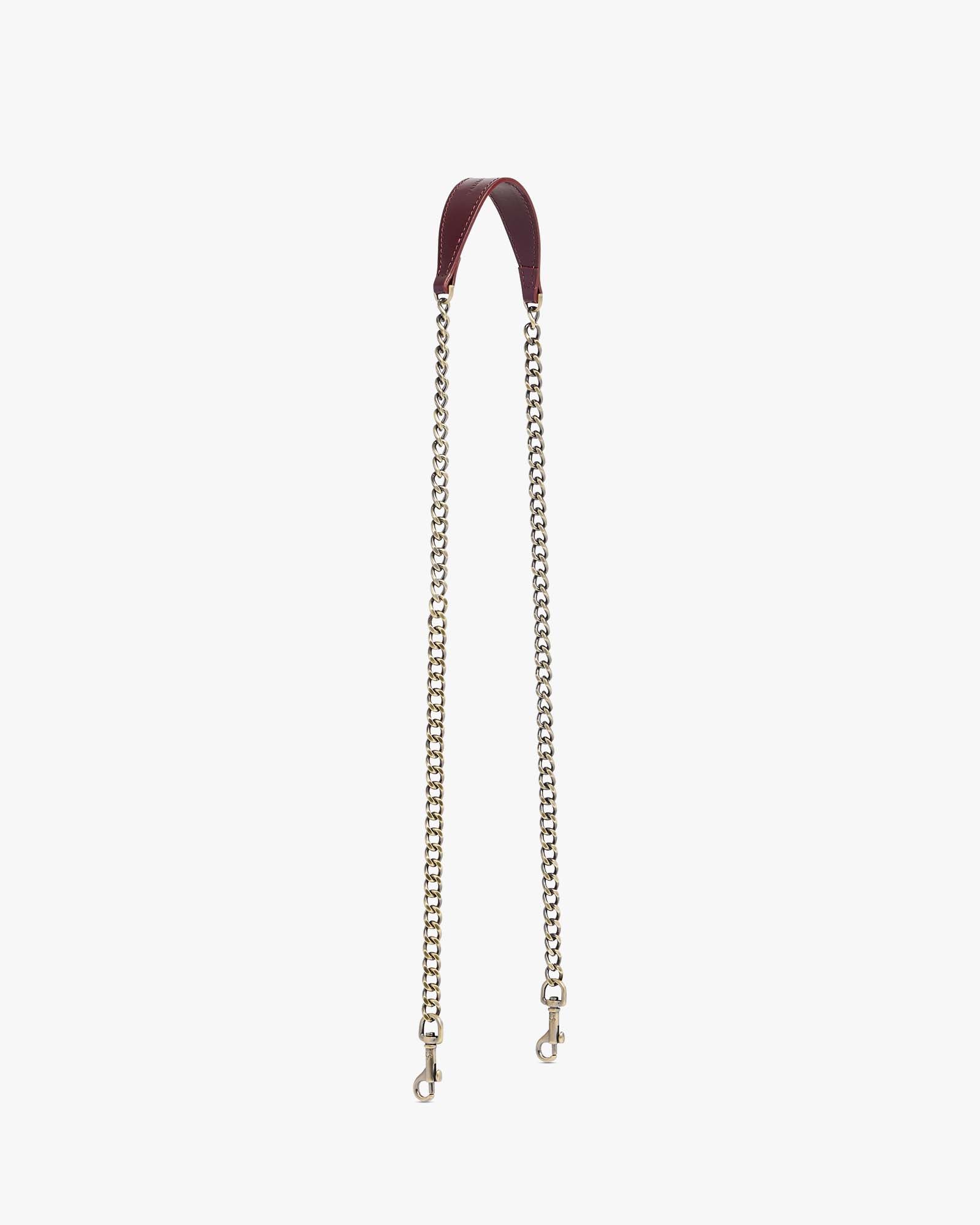 CHAÎNE LONGUE Mahogany, leather shoulder pad with aged brass chain, laid flat
