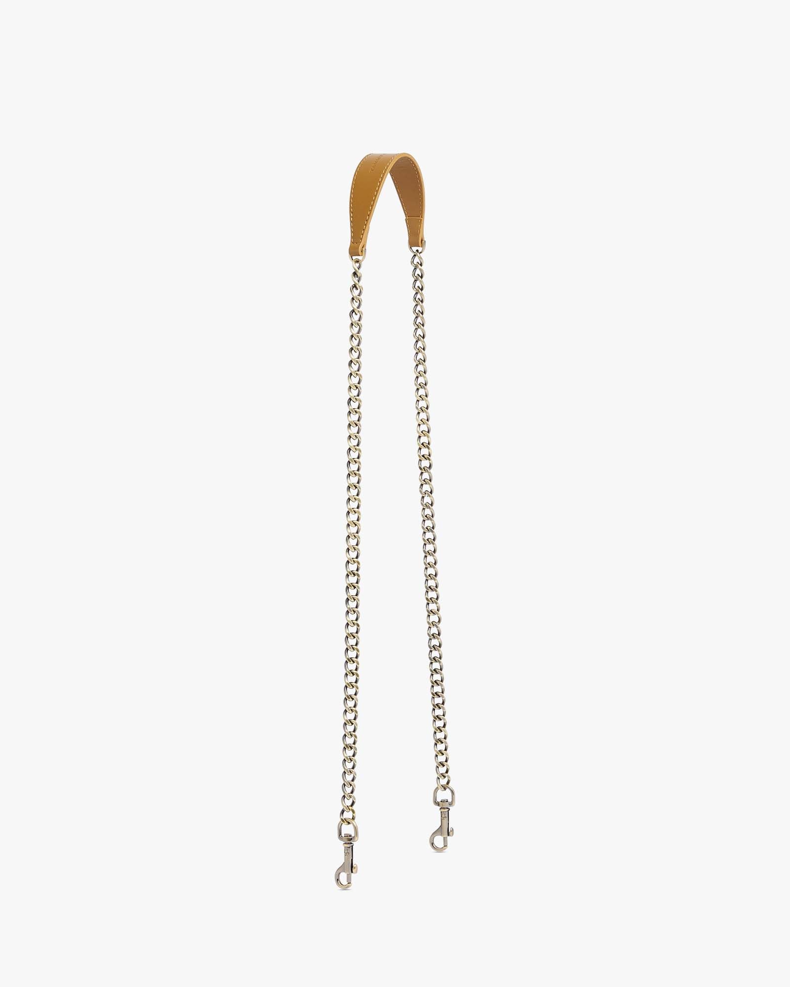 Long chain Marais, stitched leather shoulder pad, aged brass rings and clasps, laid flat