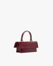 THEA MINI bag in burgundy naplak, back three-quarter view, standing, top handle raised