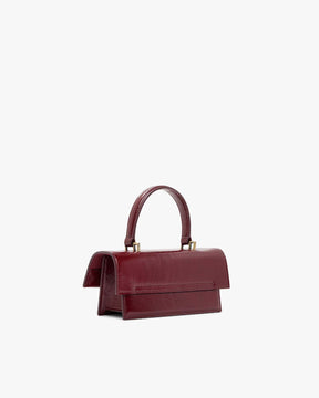 THEA MINI bag in burgundy naplak, back three-quarter view, standing, top handle raised