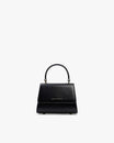 Sac ALEXIA NANO noir, vue de face, poignée rigide relevée, posé sur fond blanc