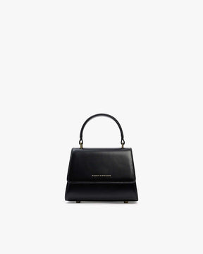 Sac ALEXIA NANO noir, vue de face, poignée rigide relevée, posé sur fond blanc