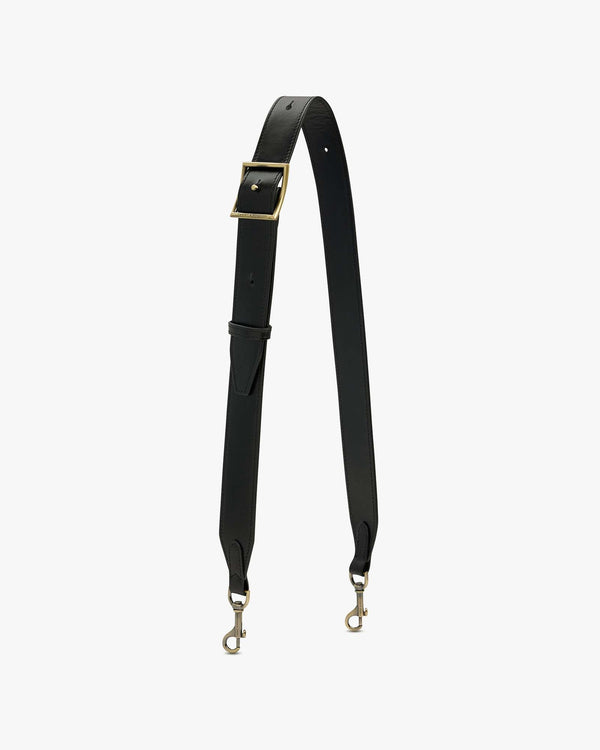 Bandoulière ajustable large en cuir noir, boucle laiton vieilli, posée en forme de V, mousquetons visibles