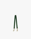 Short strap in emerald green leather, laid in a V shape, aged brass clasps at both ends