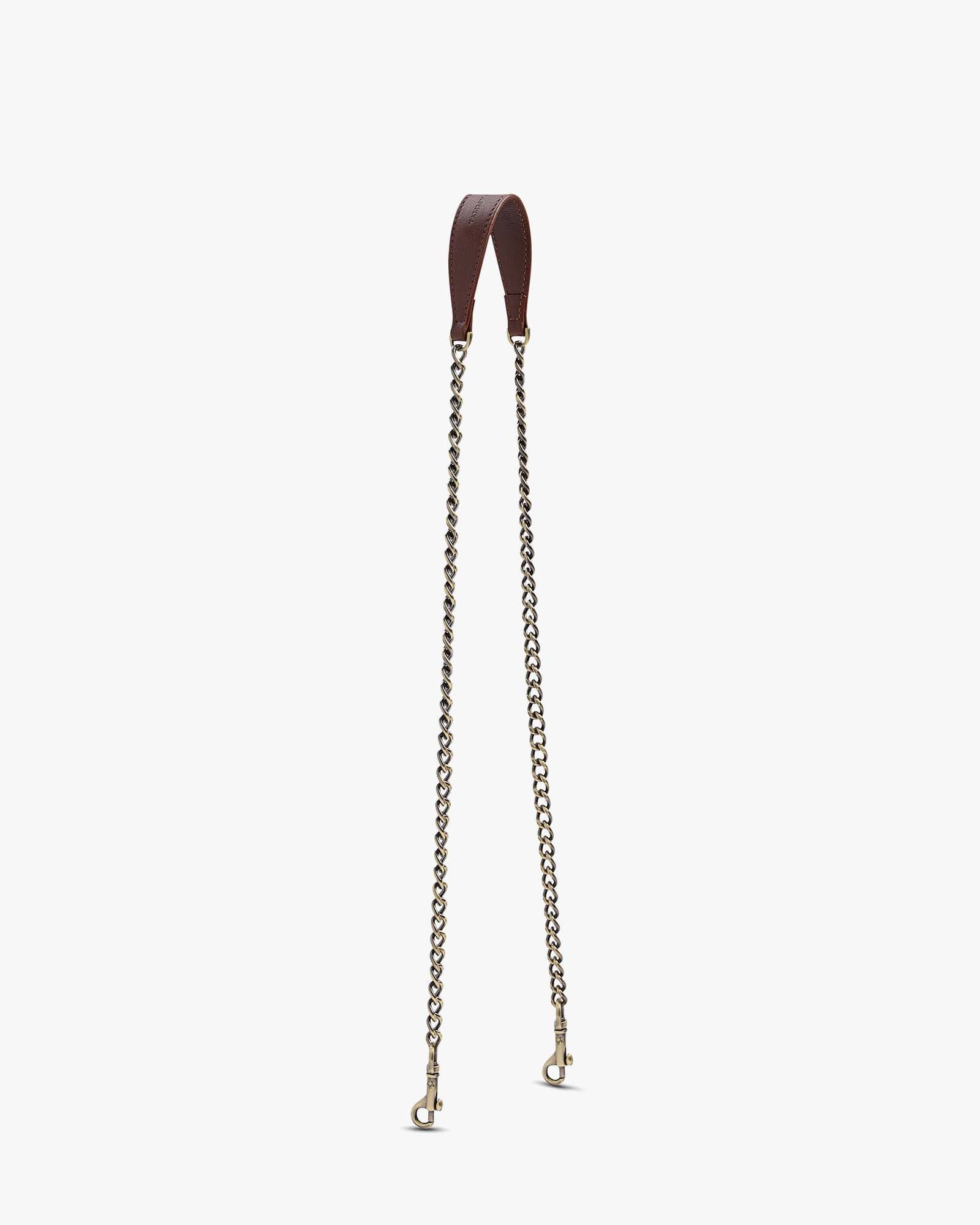 Brown long chain, leather shoulder pad, two aged brass clasps, laid flat
