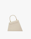 CUBIST bag in Ivoire, front view, standing, asymmetric trapeze shape with round handle