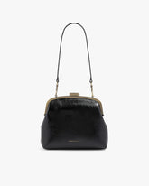 EMMA bag in black naplak, front view with long leather strap, clasp closed